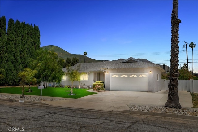 5979 Stanton Ave, Highland, CA 92346 - ranch-style home featuring a garage, driveway, and a mountain view
