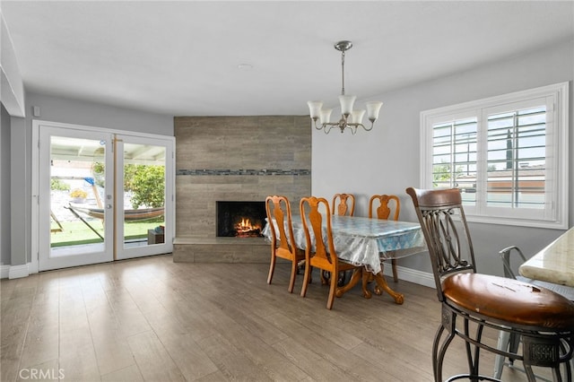 5979 Stanton Ave, Highland, CA 92346 - dining space featuring a chandelier, plenty of natural light, wood finished floors, and baseboards