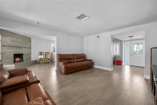 5979 Stanton Ave, Highland, CA 92346 - living room with wood finished floors, a large fireplace, and baseboards