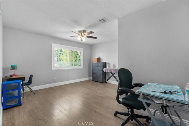 5979 Stanton Ave, Highland, CA 92346 - home office with wood finished floors, ceiling fan, and baseboards