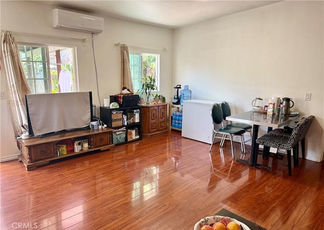 2277 Cogswell Rd, El Monte, CA 91732 - living room featuring a wall unit AC and wood finished floors
