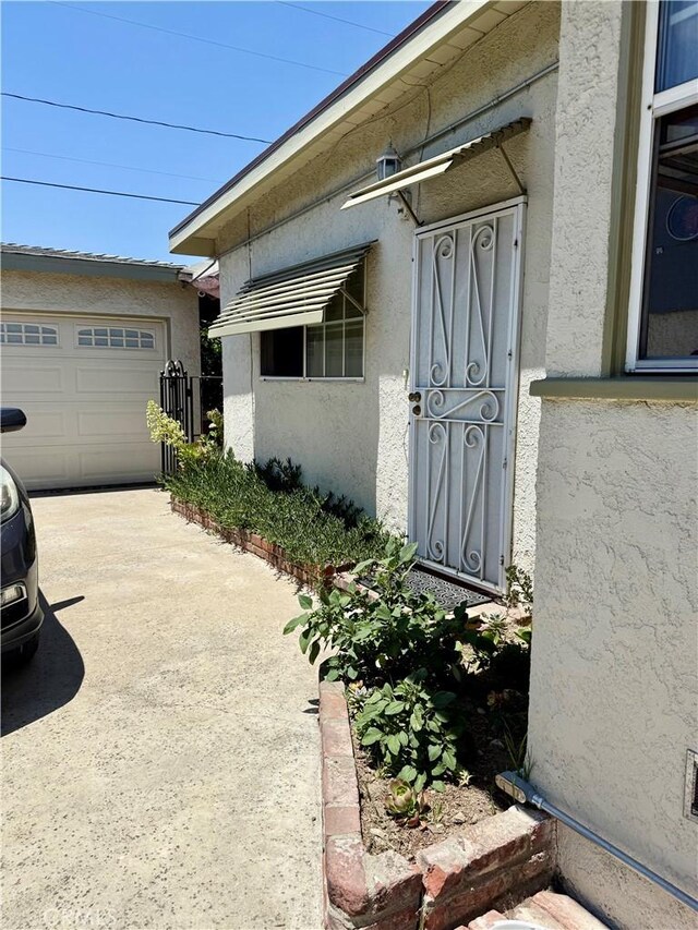 2277 Cogswell Rd, El Monte, CA 91732 - entrance to property featuring stucco siding and a garage