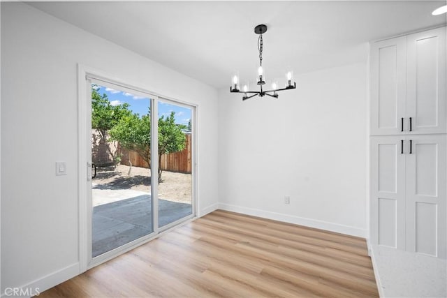 1608 Heron Ct, Redlands, CA 92374 - unfurnished dining area featuring a chandelier, light wood-style floors, and baseboards