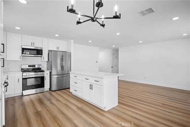 1608 Heron Ct, Redlands, CA 92374 - kitchen featuring stainless steel appliances, recessed lighting, light wood-style flooring, white cabinetry, and a chandelier