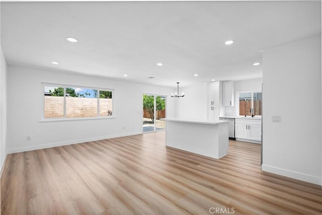 1608 Heron Ct, Redlands, CA 92374 - unfurnished living room with a chandelier, light wood-type flooring, recessed lighting, and baseboards