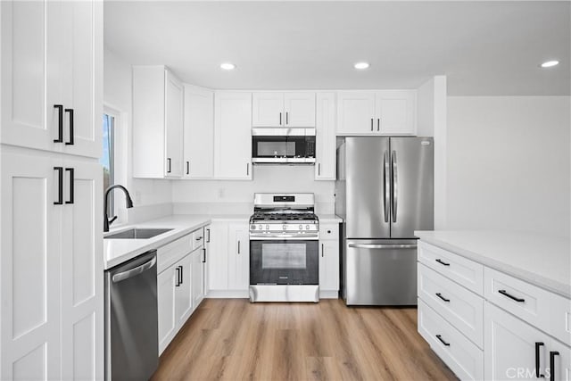 1608 Heron Ct, Redlands, CA 92374 - kitchen with appliances with stainless steel finishes, a sink, white cabinets, and recessed lighting