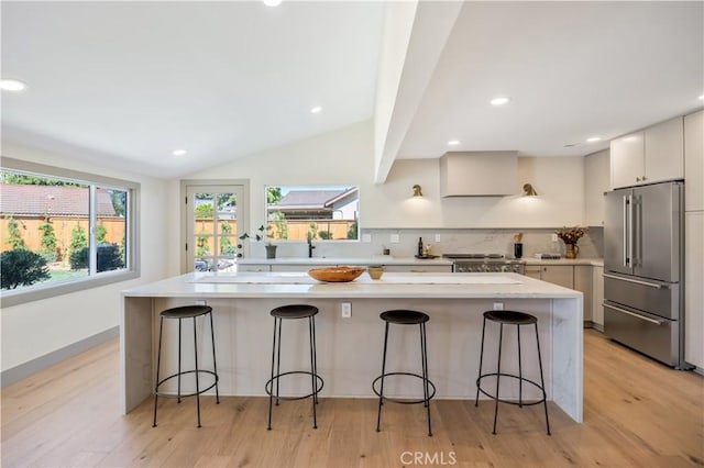 2012 Nantucket Pl, Tustin, CA 92780 - kitchen with high end fridge, light countertops, light wood-style floors, lofted ceiling, and recessed lighting