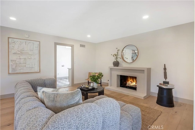 2012 Nantucket Pl, Tustin, CA 92780 - living area featuring a warm lit fireplace, light wood finished floors, recessed lighting, and baseboards