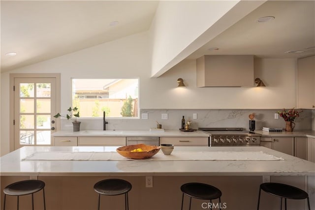 2012 Nantucket Pl, Tustin, CA 92780 - kitchen featuring a sink, appliances with stainless steel finishes, a kitchen bar, wall chimney exhaust hood, and lofted ceiling
