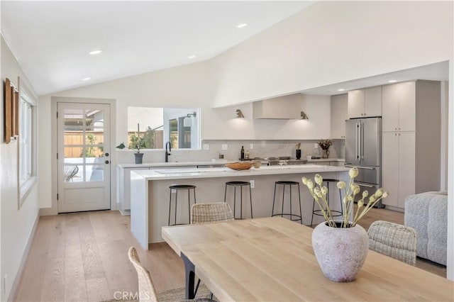 2012 Nantucket Pl, Tustin, CA 92780 - dining area featuring lofted ceiling, light wood-style floors, recessed lighting, and baseboards