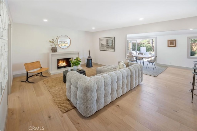 2012 Nantucket Pl, Tustin, CA 92780 - living room featuring light wood-type flooring, a warm lit fireplace, and recessed lighting
