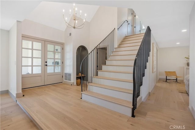 2012 Nantucket Pl, Tustin, CA 92780 - stairway with french doors, wood finished floors, a chandelier, baseboards, and recessed lighting