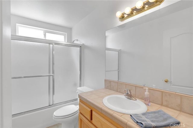 14303 Schooner Dr, Helendale, CA 92342 - bathroom with toilet, vanity, and combined bath / shower with glass door