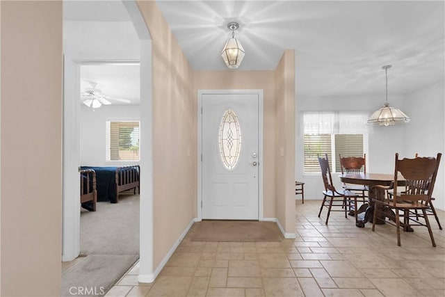 14303 Schooner Dr, Helendale, CA 92342 - entryway with healthy amount of natural light, baseboards, light stone finish flooring, and arched walkways