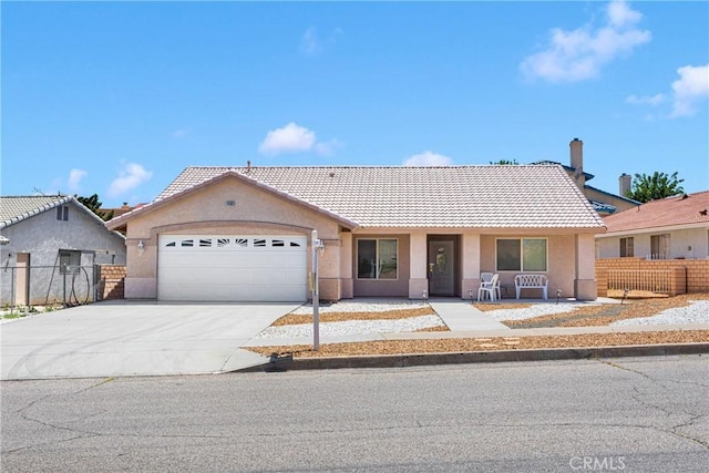 14303 Schooner Dr, Helendale, CA 92342 - ranch-style home with a tiled roof, an attached garage, stucco siding, and concrete driveway