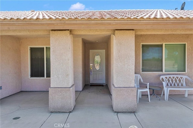 14303 Schooner Dr, Helendale, CA 92342 - entrance to property with stucco siding, a patio, and a tile roof