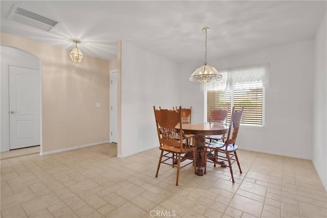 14303 Schooner Dr, Helendale, CA 92342 - dining area with a chandelier, arched walkways, and baseboards