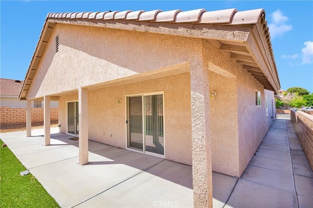 14303 Schooner Dr, Helendale, CA 92342 - rear view of house featuring stucco siding and a patio area