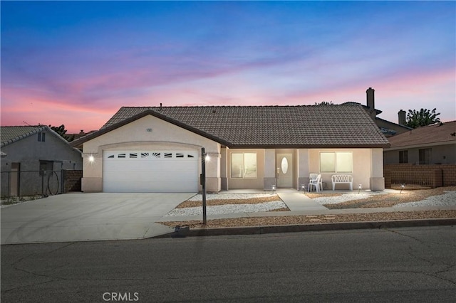14303 Schooner Dr, Helendale, CA 92342 - ranch-style home with driveway, a garage, stucco siding, and a tile roof