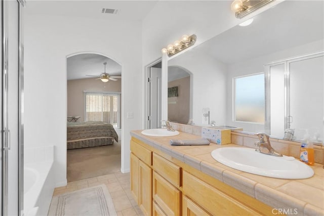 14303 Schooner Dr, Helendale, CA 92342 - full bathroom with connected bathroom, ceiling fan, a bath, double vanity, and tile patterned floors