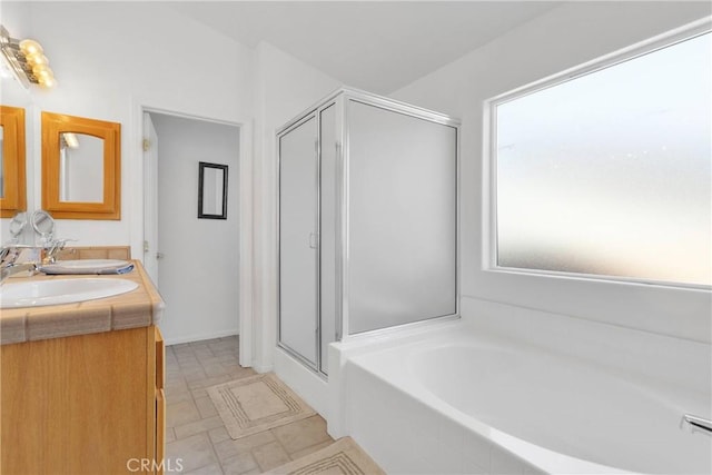 14303 Schooner Dr, Helendale, CA 92342 - bathroom featuring a bath, a shower stall, and double vanity