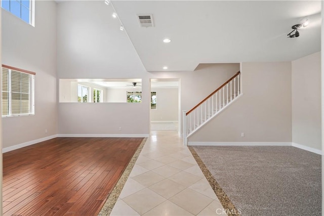 2207 Cork Oak St, Palmdale, CA 93551 - unfurnished living room featuring ceiling fan, baseboards, stairway, recessed lighting, and track lighting