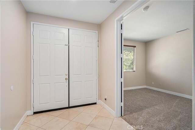 2207 Cork Oak St, Palmdale, CA 93551 - unfurnished bedroom featuring baseboards, a closet, and light tile patterned floors