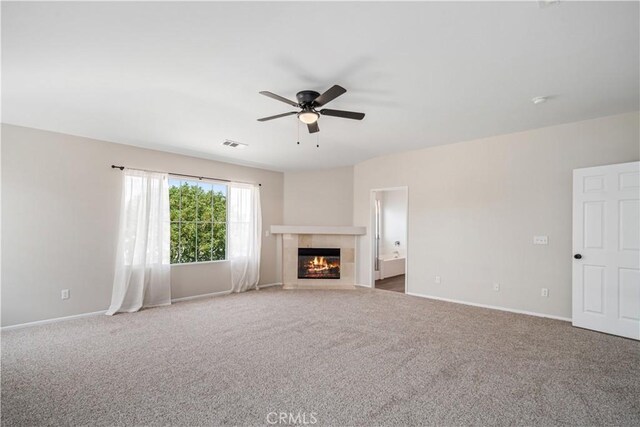 2207 Cork Oak St, Palmdale, CA 93551 - unfurnished living room featuring ceiling fan, a tiled fireplace, carpet, and baseboards