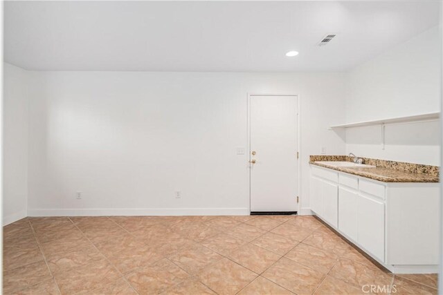 2207 Cork Oak St, Palmdale, CA 93551 - kitchen with a sink, open shelves, white cabinetry, stone countertops, and recessed lighting