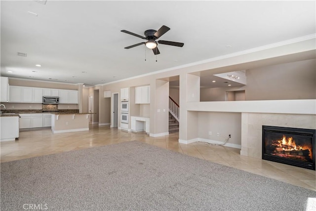 2207 Cork Oak St, Palmdale, CA 93551 - unfurnished living room with ornamental molding, light tile patterned flooring, a premium fireplace, recessed lighting, and stairs
