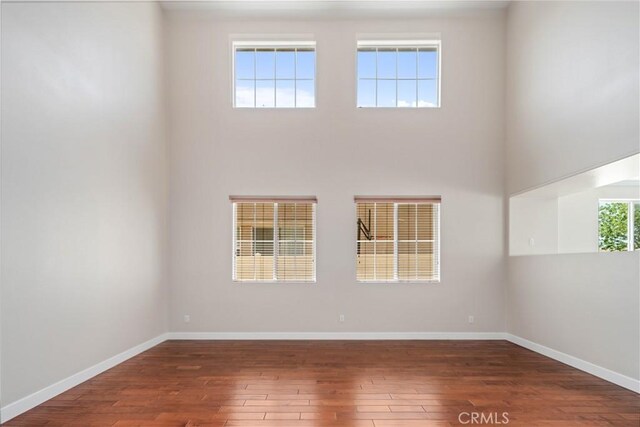 2207 Cork Oak St, Palmdale, CA 93551 - unfurnished room with hardwood / wood-style floors, baseboards, and a high ceiling