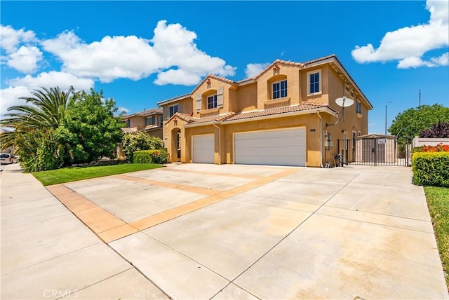 2207 Cork Oak St, Palmdale, CA 93551 - mediterranean / spanish home featuring a gate, a garage, a tiled roof, concrete driveway, and stucco siding
