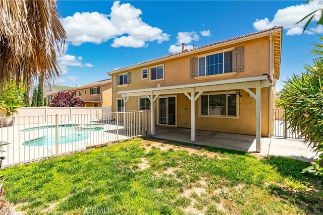 2207 Cork Oak St, Palmdale, CA 93551 - back of house with stucco siding and a patio