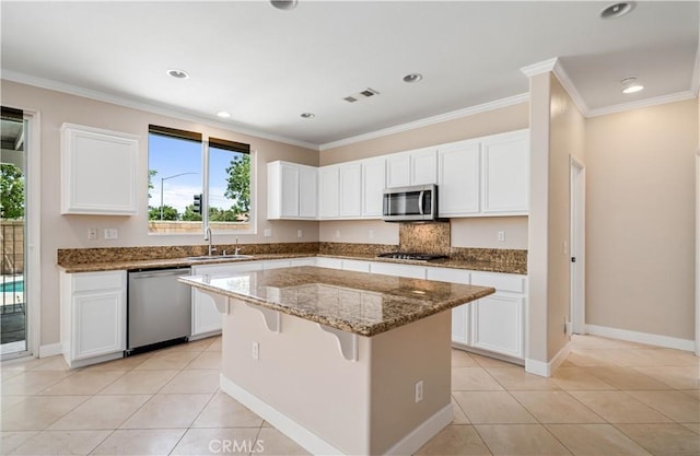 2207 Cork Oak St, Palmdale, CA 93551 - kitchen with stainless steel appliances, a sink, stone counters, a center island, and white cabinets