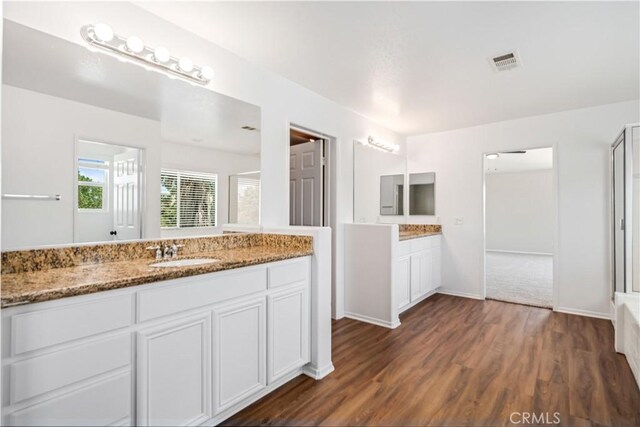 2207 Cork Oak St, Palmdale, CA 93551 - bathroom with vanity, wood finished floors, an enclosed shower, and a bathtub