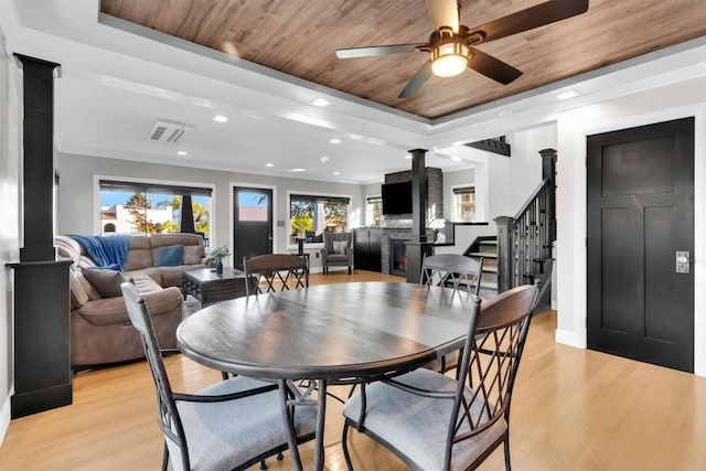 3388 Bancroft St, San Diego, CA 92104 - dining area featuring decorative columns, a ceiling fan, a tray ceiling, light wood-type flooring, and wood ceiling