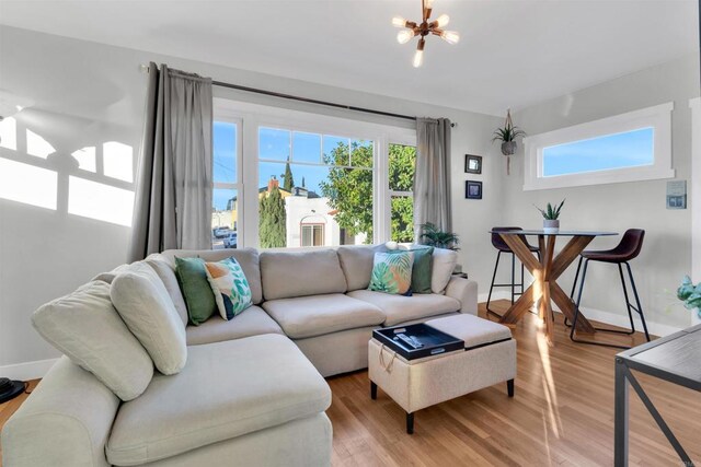 3388 Bancroft St, San Diego, CA 92104 - living room with light wood-type flooring, a chandelier, and baseboards