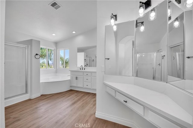 29 Villa Valtelena, Lake Elsinore, CA 92532 - bathroom with a shower stall, wood finished floors, a bath, vanity, and recessed lighting