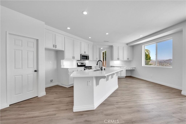 29 Villa Valtelena, Lake Elsinore, CA 92532 - kitchen featuring appliances with stainless steel finishes, a sink, white cabinets, light wood-style floors, and light countertops