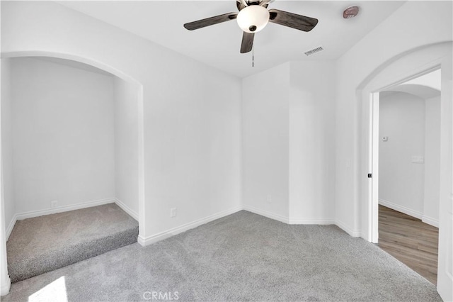 29 Villa Valtelena, Lake Elsinore, CA 92532 - unfurnished room featuring arched walkways, ceiling fan, carpet, and baseboards