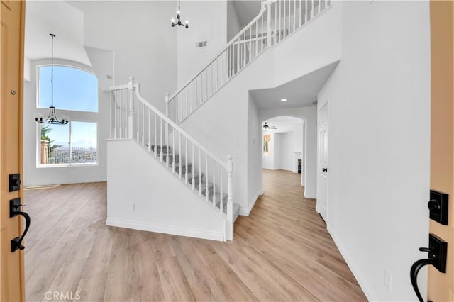 29 Villa Valtelena, Lake Elsinore, CA 92532 - entrance foyer with a chandelier, wood finished floors, a high ceiling, arched walkways, and baseboards