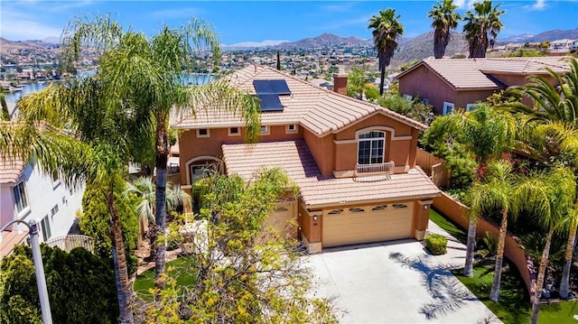 29 Villa Valtelena, Lake Elsinore, CA 92532 - mediterranean / spanish home featuring stucco siding, roof mounted solar panels, driveway, a tile roof, and a garage