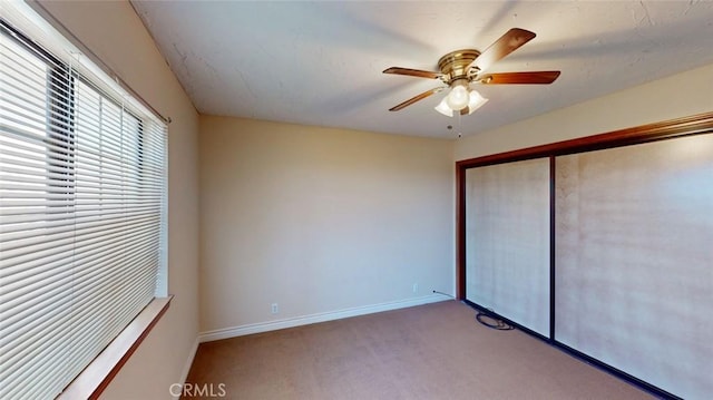 13889 Olathe Rd, Apple Valley, CA 92307 - unfurnished bedroom with carpet flooring, baseboards, a closet, and a ceiling fan
