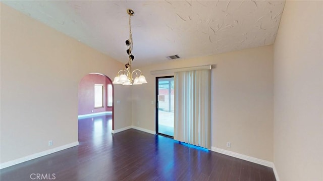 13889 Olathe Rd, Apple Valley, CA 92307 - empty room with arched walkways, dark wood-style floors, baseboards, a chandelier, and lofted ceiling
