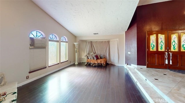 13889 Olathe Rd, Apple Valley, CA 92307 - foyer featuring wood finished floors, baseboards, high vaulted ceiling, and a textured ceiling
