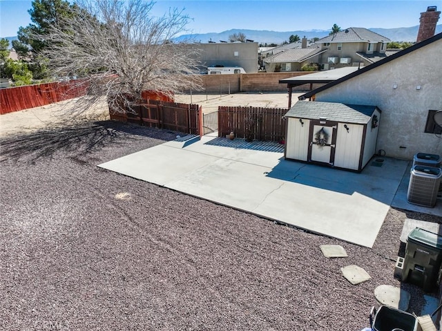 13889 Olathe Rd, Apple Valley, CA 92307 - fenced backyard with a patio area, central AC, a mountain view, and a residential view