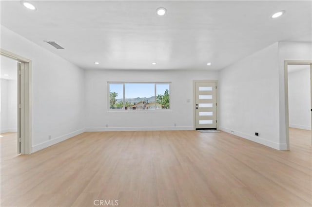 61730 Oleander Dr, Joshua Tree, CA 92252 - unfurnished living room featuring light wood-style floors, recessed lighting, and baseboards