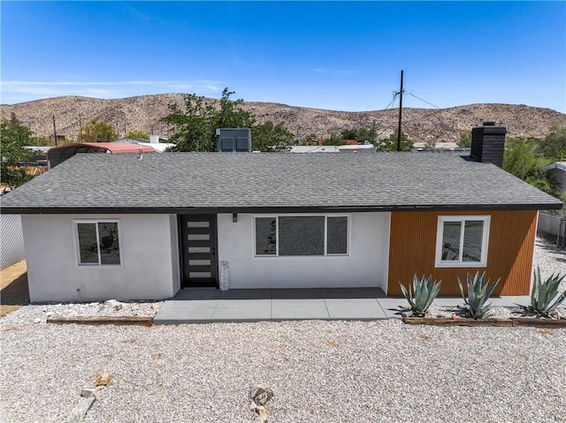 61730 Oleander Dr, Joshua Tree, CA 92252 - view of front of property with a shingled roof, a mountain view, and a chimney