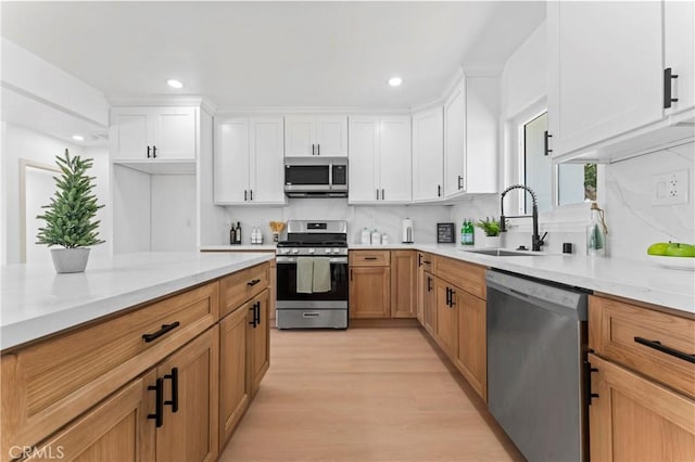 61730 Oleander Dr, Joshua Tree, CA 92252 - kitchen featuring stainless steel appliances, a sink, light wood-style floors, white cabinetry, and recessed lighting