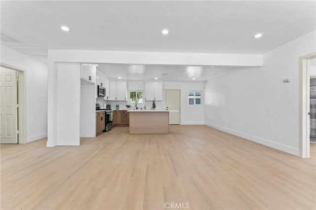61730 Oleander Dr, Joshua Tree, CA 92252 - unfurnished living room featuring baseboards, recessed lighting, and light wood-style floors